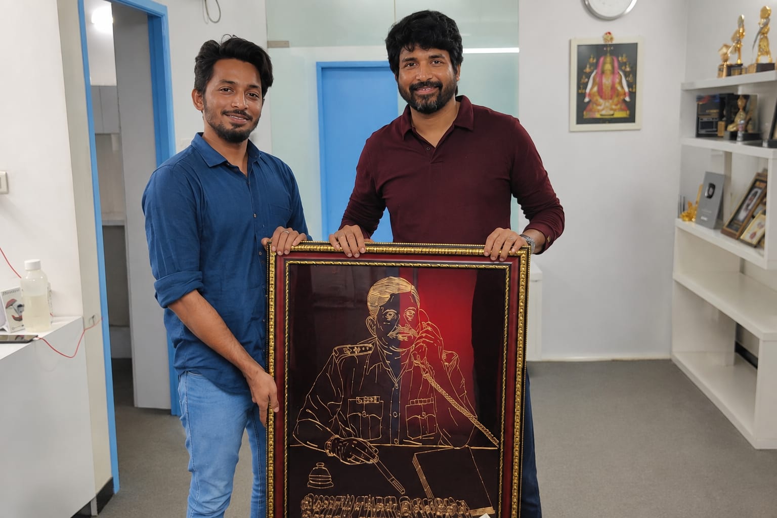 Actor Sivakarthikeyan receiving his father's portrait